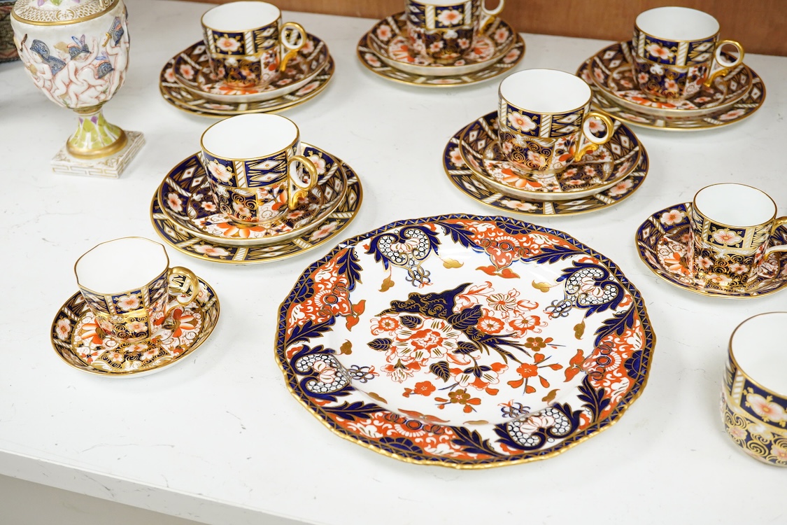 A Crown Derby Imari seven trio place setting, three other cups and two saucers, a large plate and a pair of Doccia- style vases, 18cm high